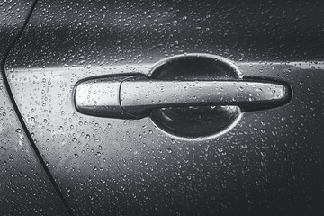 wet silver handle door of a car