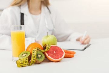 Nutritionist desk with fruit and measuring tape