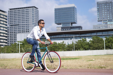 Fototapeta na wymiar Young Man Biking in a Summer Day