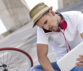 Young man relaxing on the floor and listening music