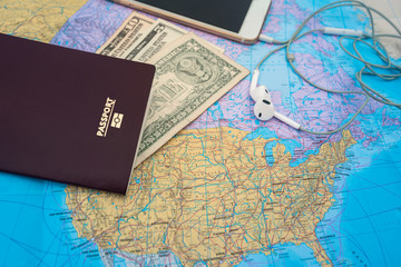 Fototapeta na wymiar Passport with blank and smart phone and earphones on a world map background