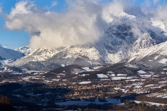 The village of Saint-Bonnet-en-Champsaur and the Petit Chaillol mountain peak in winter. Drac Valley, Hautes-Alpes, French Alps, France