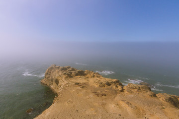 high coastal landscape covered in fog in Oregon, USA