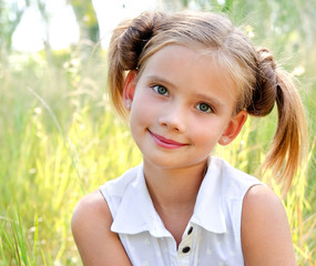 Portrait of adorable smiling little girl in summer day outdoor 