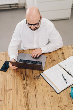 High-angle view of man using wireless laptop