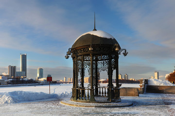 photo of an iron gazebo under the snow