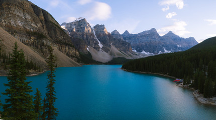Fototapeta na wymiar Blue water of Moraine Lake in Rocky Mountains in Canada during colorful sunset
