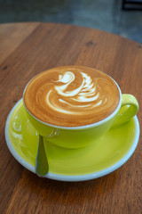 Latte coffee cup on wooden table.
