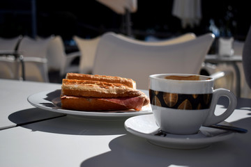 Good Morning Breakfast with ham and cheese sandwich and cup of coffee with milk
