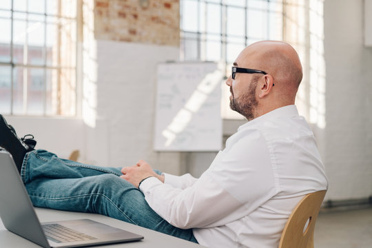 Businessman relaxing with his feet on the desk