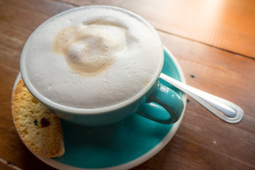 glass of cappuccino coffee on wooden