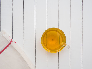 Glass cup of green tea on a white wooden table