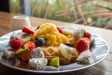 fresh healthy fruit salad on wooden background
