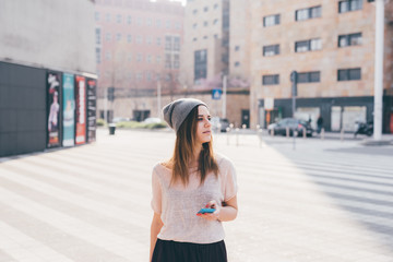 Young woman outdoor using smart phone hand hold looking away - technology, social network, phubbing...
