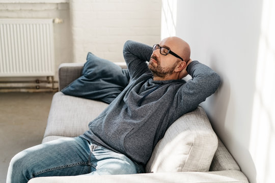 Middle-aged man relaxing on the couch indoors