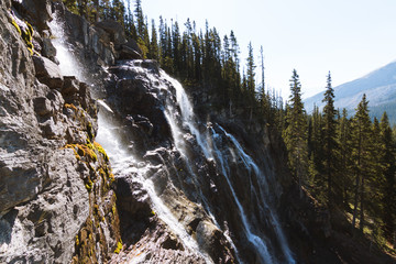 Fototapeta na wymiar Waterfalls in forest in Rocky Mountains, Jasper on sunny day