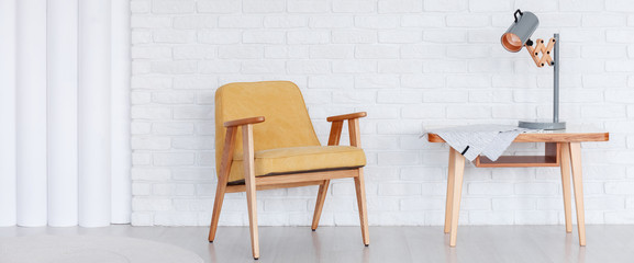 Yellow retro armchair in room