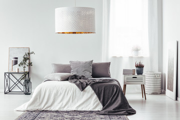White lamp above bed