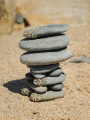 Fototapeta na wymiar Stack of grey pebbles on the beach