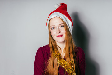 young girl smiles timidly in the New Year's cap