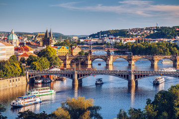 Fototapeta na wymiar View of the Vltava River and the bridges shined with the sunset sun, Prague, the Czech Republic