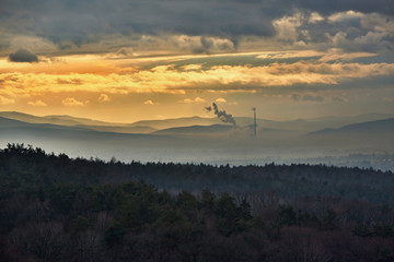 Smog hell - sunset. View from afar the city and a factory chimney with lots of smoke and smog....