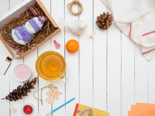 Glass cup of green tea and tangerine on a white wooden table