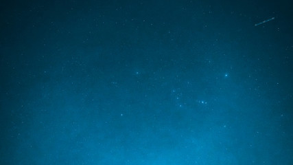 blue background from night sky with bright small star and special seeing gemini meteor from...
