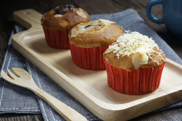 Three banana cup cake on wooden plate