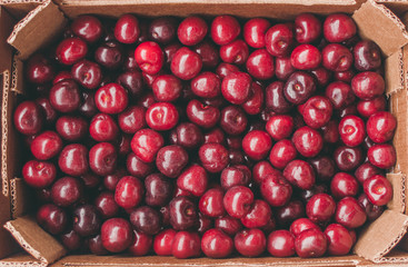 a brown box full of cherries