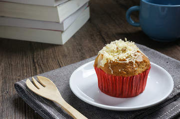 banana cup cake on white plate with book in background