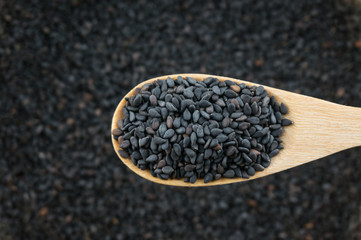 Close up black sesame in wooden spoon