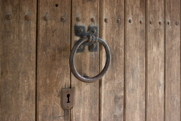 Retro door knocker on a wooden door