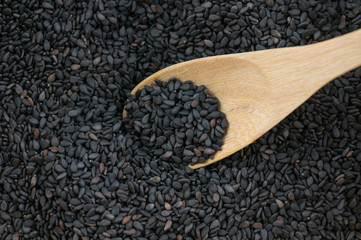Close up black sesame in wooden spoon