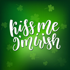 Saint Patricks Day greeting card with sparkled green clover leaves and text. Inscription - Kiss Me, I am Irish. St. Patricks Day lettering. Vector holiday poster sign on blurred green background