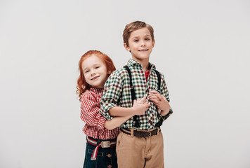 adorable little kids hugging and smiling at camera isolated on grey