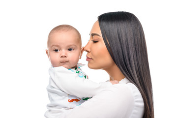 portrait of tender young woman and cute little baby isolated on white