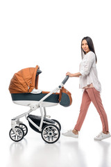 side view of young woman with infant baby in baby carriage isolated on white