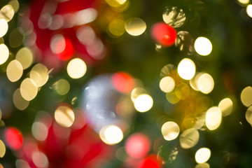 Obraz na płótnie Canvas Colorful Red, Yellow and Green Christmas Tree Bokeh background of de focused glittering lights,