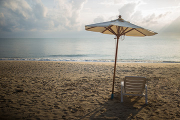 A Umbrella and a beach chair on the beach in the morning.