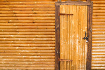 old weathered wooden door with a leather cord