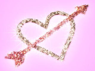 Heart and Cupid's Arrow made of diamonds on a pink background