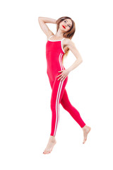 young beautiful woman in the red sports jumpsuit jumping of joy. Young sporty fit emale model isolated on white background in full body.