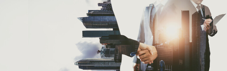 double exposure handshake on a city background