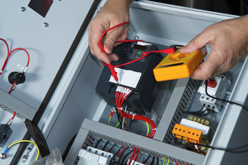 technician at maintenance work with an electric pump