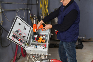 technician at maintenance work with an electric pump