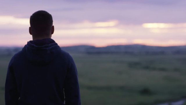 Successful man looking up to sunset sky celebrating enjoying freedom. Positive human emotion feeling life perception success, peace of mind concept. Free happy man