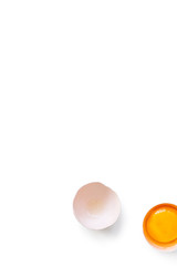 fresh brown organic chicken egg broken with yolk and egg white isolated on white background. Vertical composition. Top view