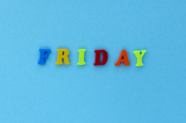 word "friday" of plastic magnetic letters on blue background