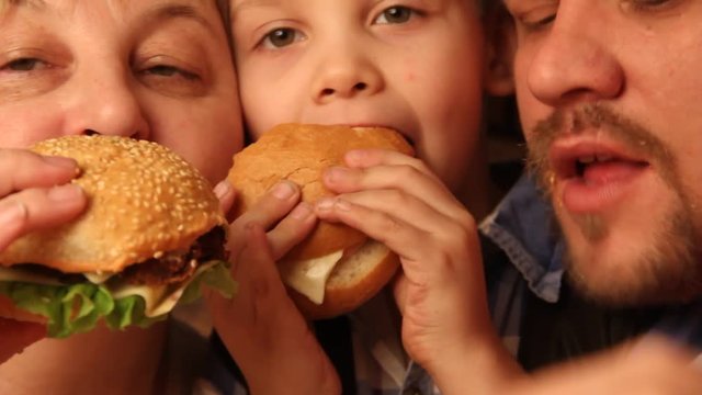 close-up of a family eating hamburgers